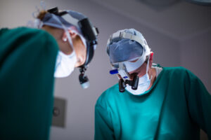 Surgeons wearing surgical loupes while performing operation in operation theater